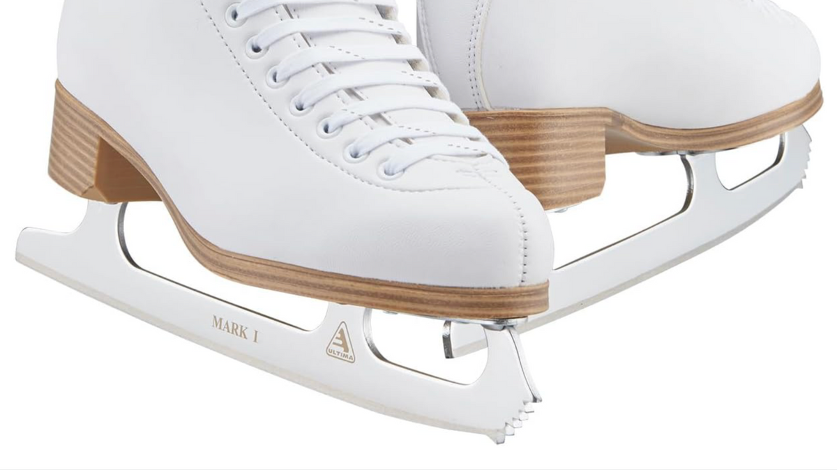 White figure skates on ice used for beginner skating lessons